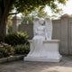 Marble seated angel chest headstone shown on a churchyard plot