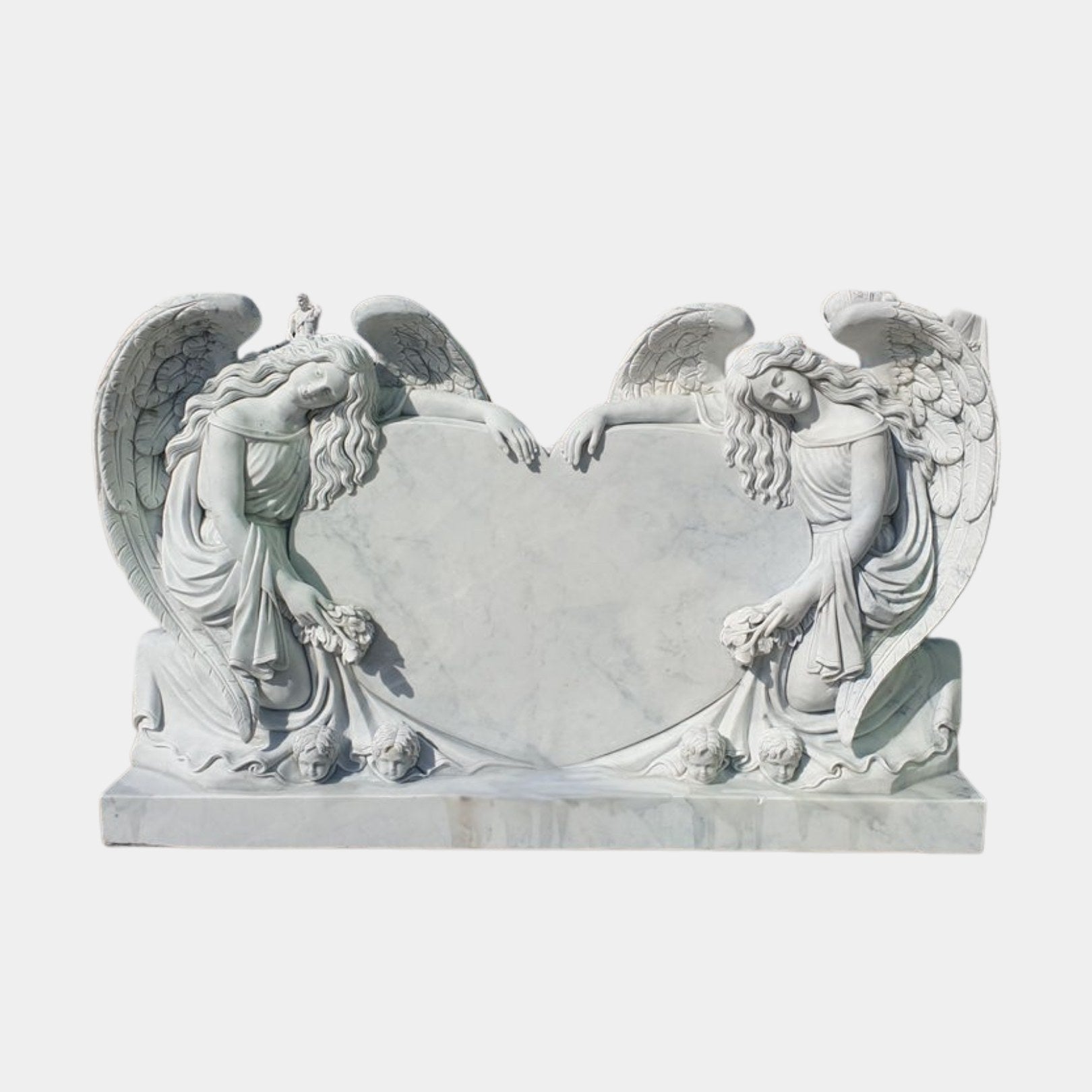 White marble headstone with two angels over a heart tablet above carved cherub heads, 130cm