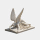 White marble angel lying full length across a flat ledger over carved roses, 100cm