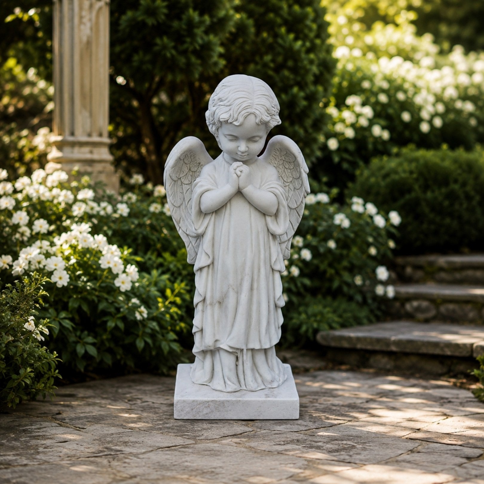 Marble praying child angel memorial shown on a small lawn plot