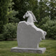 Grey granite horse head memorial shown on a lawn