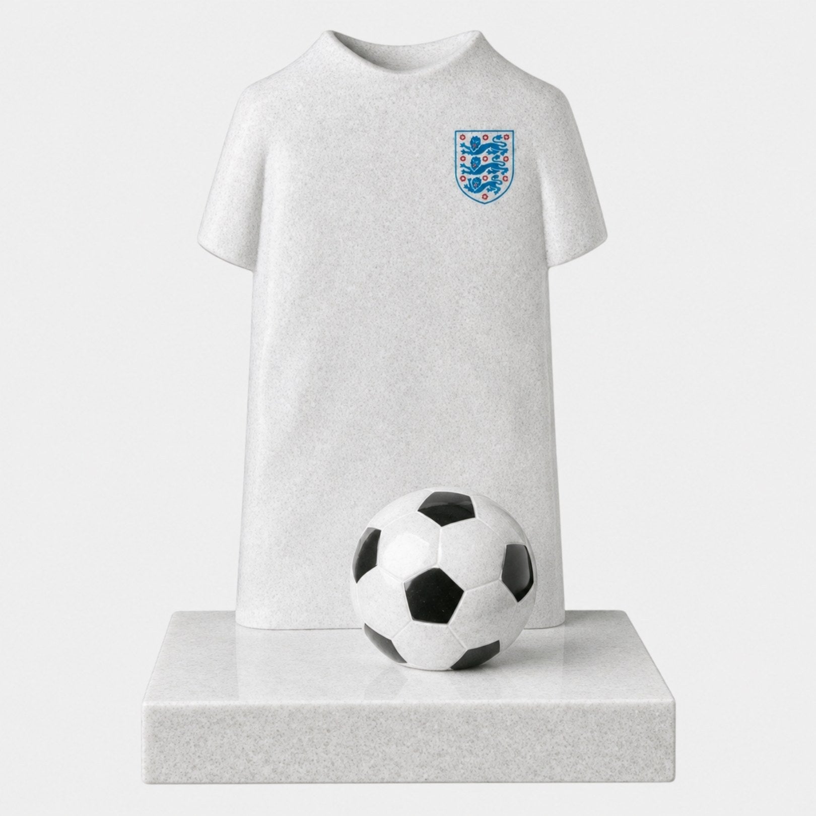 Pale white and grey stone child memorial carved as a football shirt with a ball, 120cm
