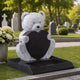 Granite bear and heart memorial with a planting tray shown on a lawn