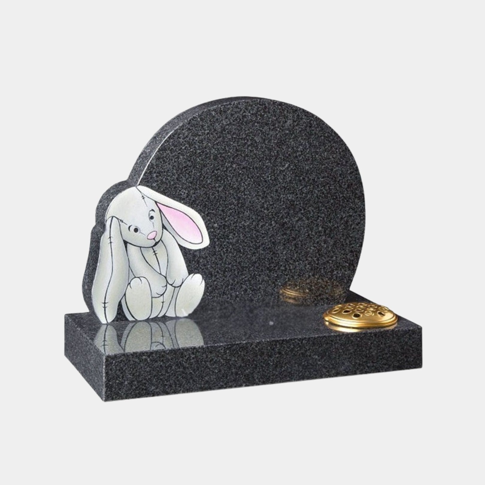 Grey granite child memorial with a painted toy rabbit and a brass flower grille, 100cm