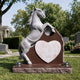 The rearing horse memorial on a cemetery lawn, its heart panel still blank