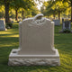 Grey stone infant relief memorial shown on a rock-faced plinth