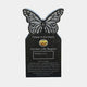 Black granite butterfly headstone with frosted wing cells on a tablet
