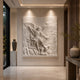 The archangel relief mounted and downlit on a modern hallway wall