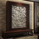 Grey stone peony and bird relief panel shown backlit in a timber frame