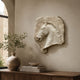 Marble horse head relief with antiqued rough ground shown on a wall