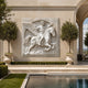 Winged rider marble relief panel in a stepped square border shown on a wall