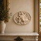 Small oval marble Venus relief plaque shown on a hallway wall
