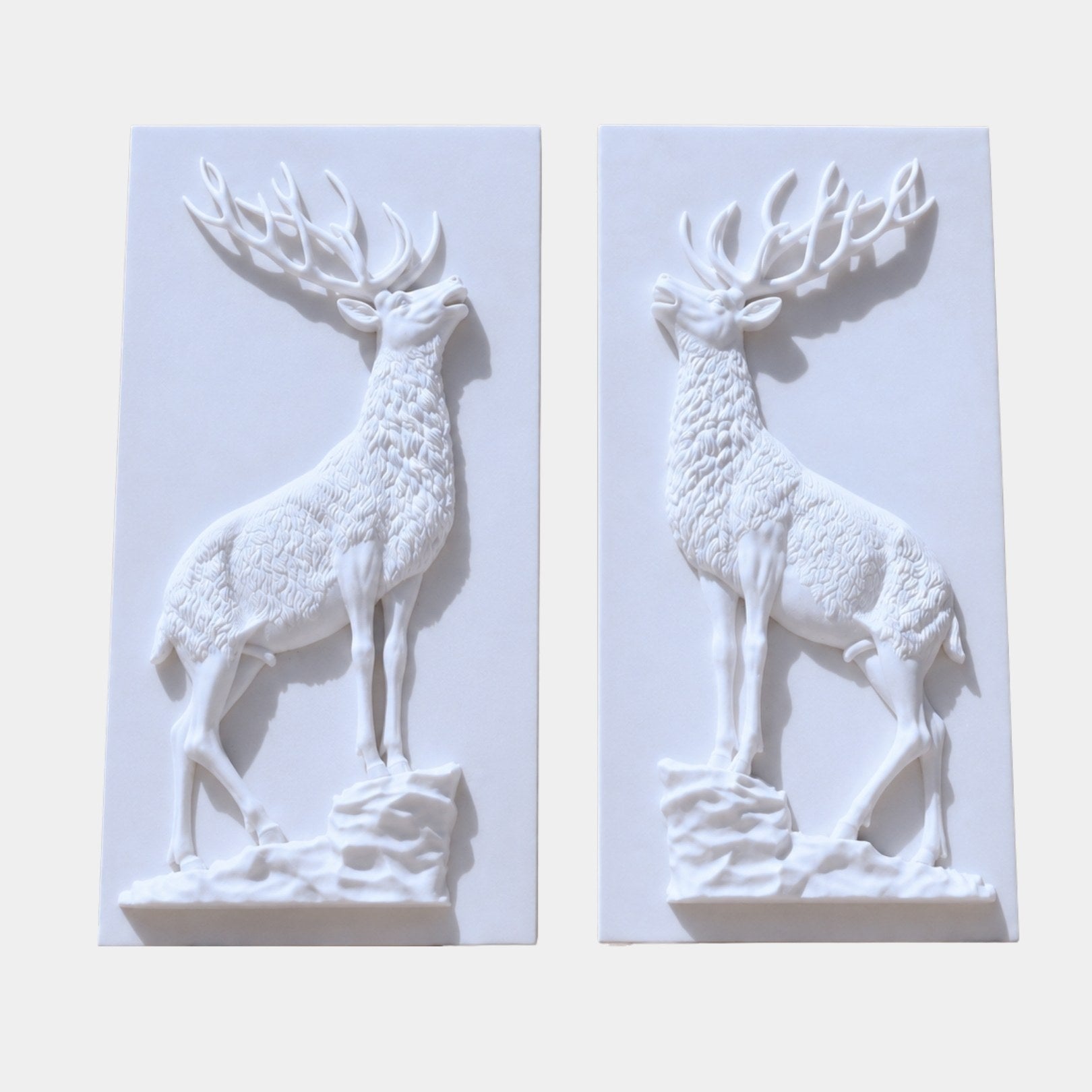 White marble relief panel 150cm with a standing stag on rocky ground, antlers cut free