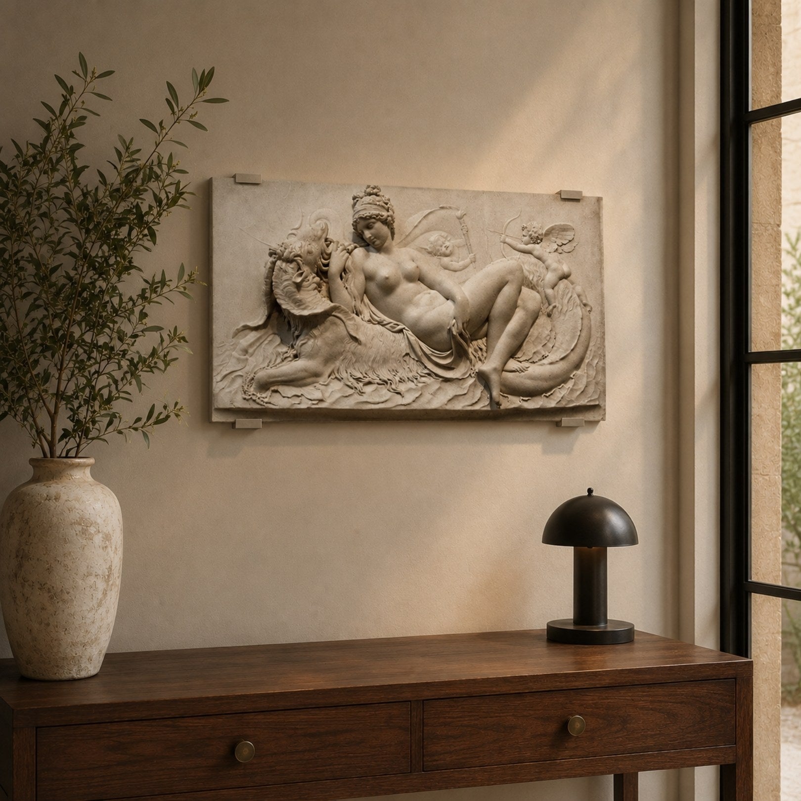 Reclining nude marble relief panel shown above a bedroom headboard