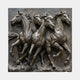 Bronze relief panel of four galloping horses with their manes flying