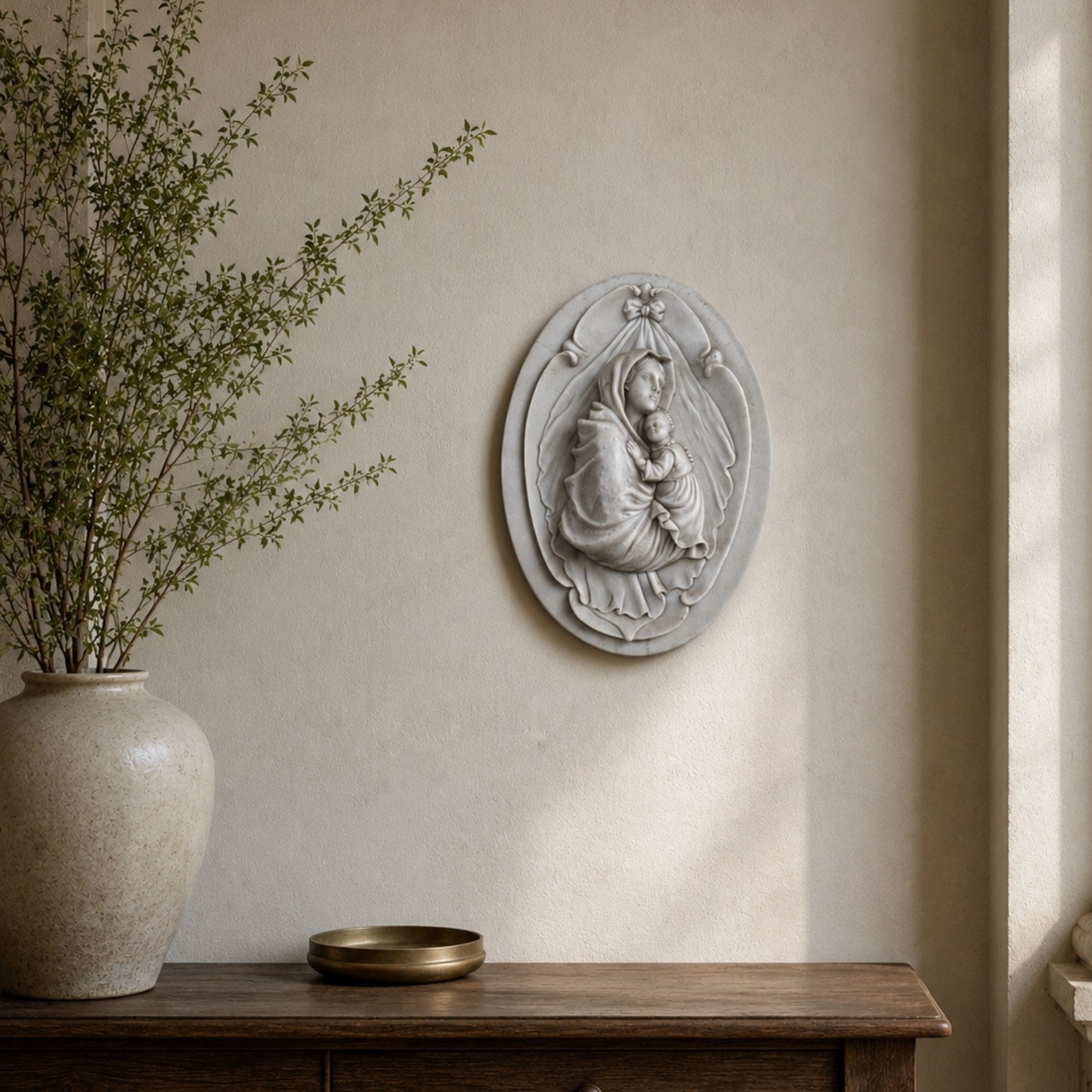 Veiled Madonna oval marble plaque shown in a hallway niche