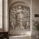Marble relief shown set into an arched masonry niche in a chapel wall