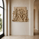 Attended youth stone relief shown wall-mounted on a plain plaster wall