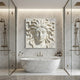 Medusa head marble relief slab shown on a plain gallery wall