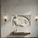 Reclining mermaid marble relief shown wall-mounted between two sconces