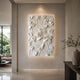Botanical marble bas-relief panel shown along a long hallway wall