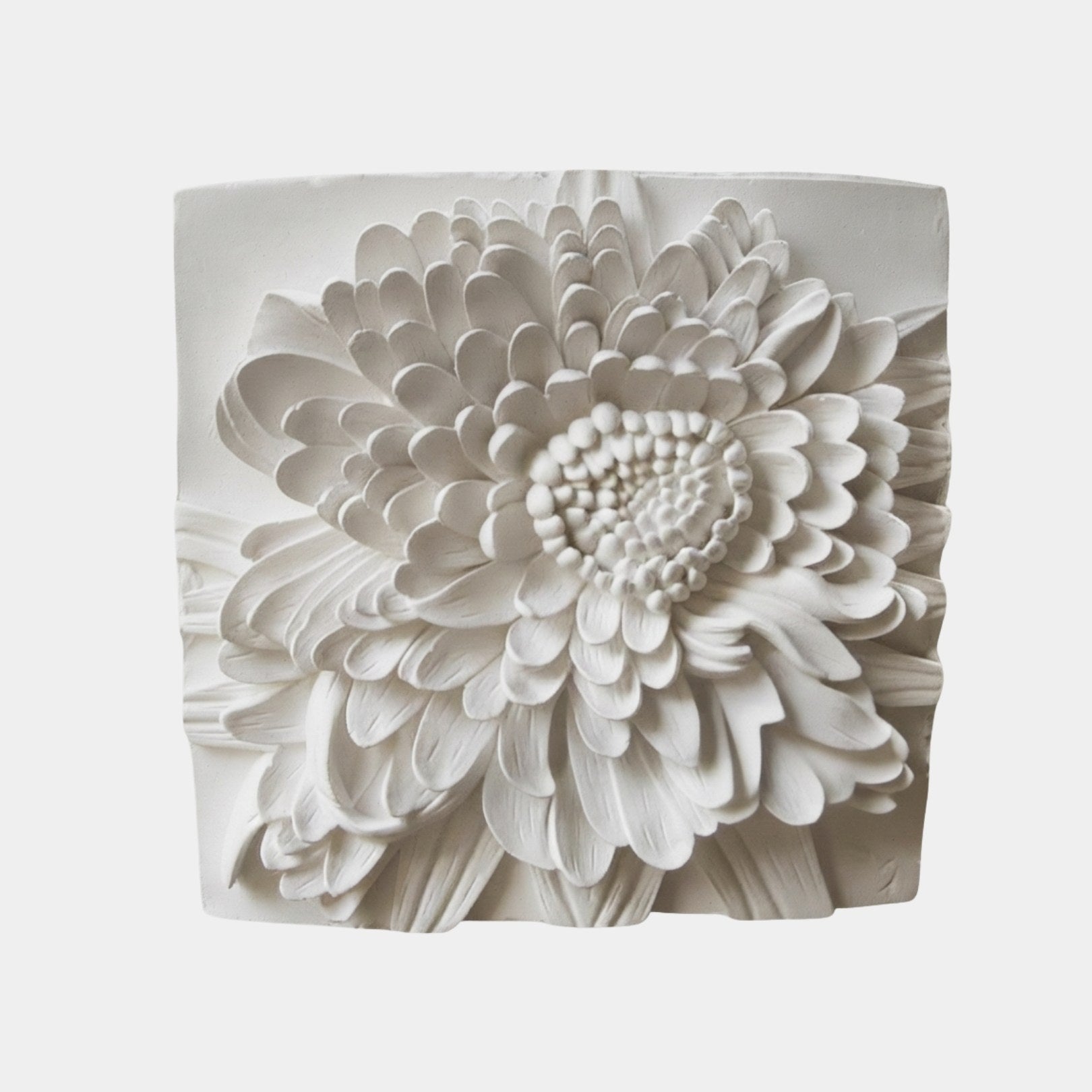 Marble relief of one chrysanthemum bloom filling the panel, petals in courses