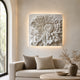 The chrysanthemum relief above a sofa in a plastered living room
