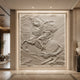 Marble rider and rearing horse relief shown wall-mounted in a lit recess