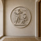 The harvest roundel mounted on a plastered hallway wall beside an arch