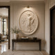 Marble oval figure relief shown wall-mounted above a console under a picture light