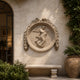 Marble flower gatherer roundel shown wall-mounted on an ashlar garden wall