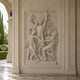 Bacchic marble relief panel shown wall-mounted in a panelled loggia recess