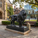 Roaring Lion Polished Black Granite Statue, 120cm, on a stone base outdoors near a campus building, bench, and lamp post.