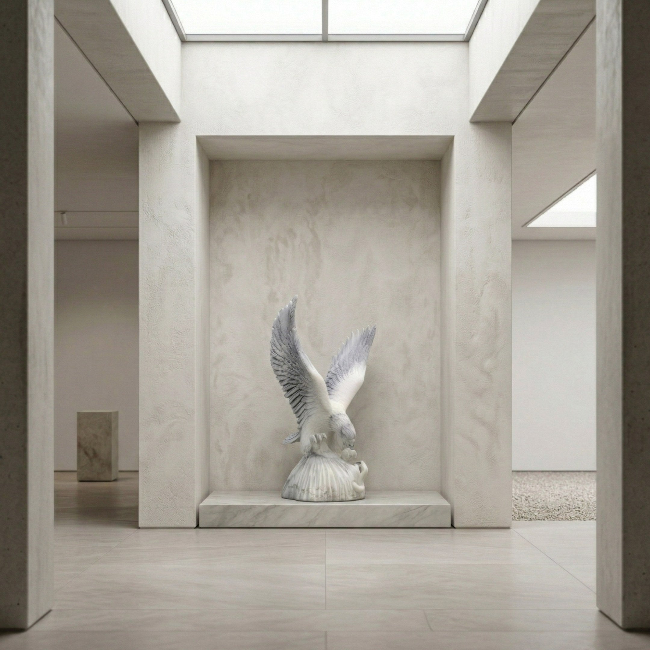 The Swooping Eagle Marble Outdoor Sculpture - 200cm by Giant Sculptures stands with wings spread on a pedestal in a minimalist, sunlit gallery with textured walls and a skylight, echoing classic garden elegance.
