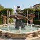 Monumental Classical Female Figure on Dolphin Bronze Sculpture by Giant Sculptures, 350cm, on stone plinth in a garden fountain with columns and flowers.