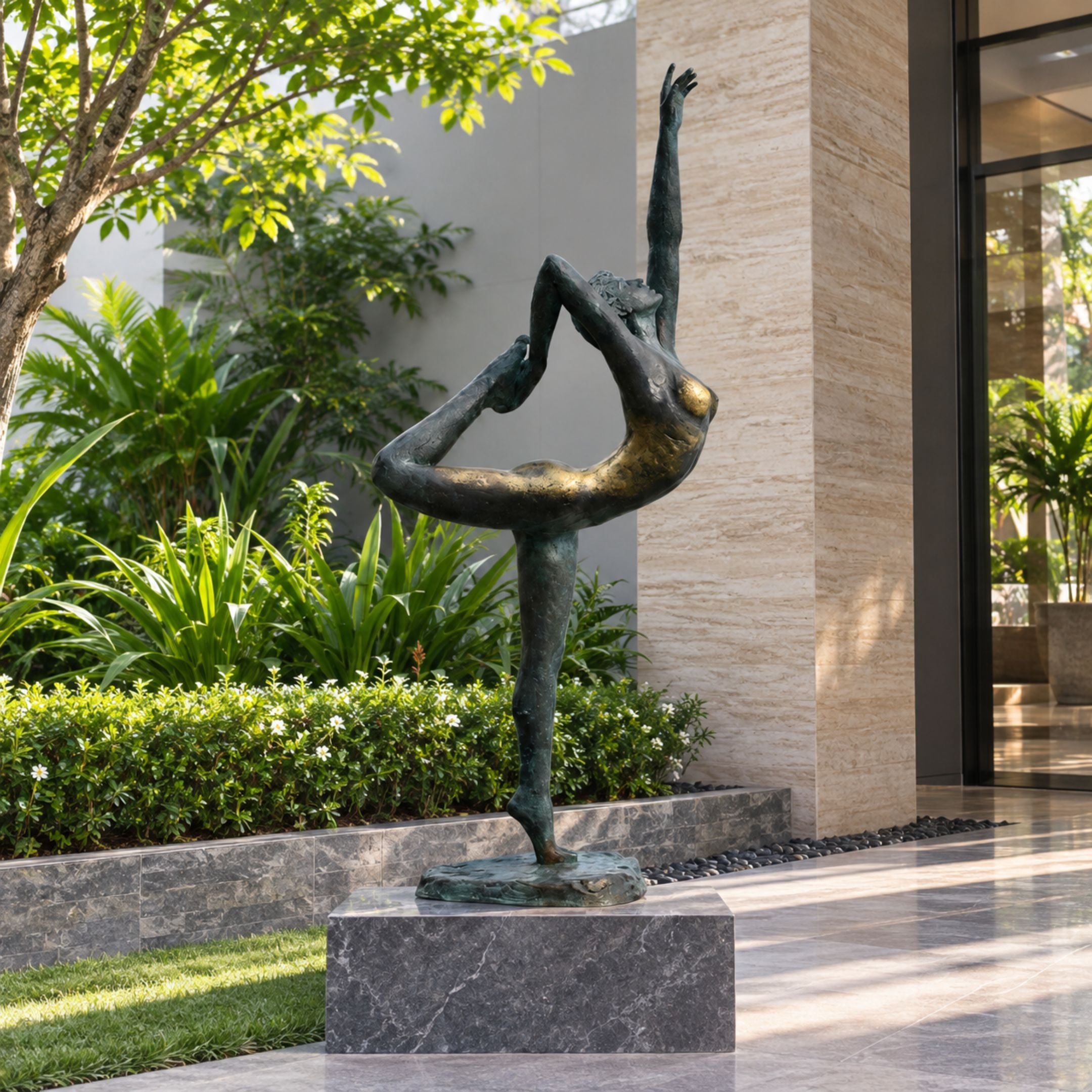 Monumental Contemporary Dancer Bronze Sculpture, 330cm, in a bronze and gold arabesque pose on a stone base, displayed outdoors near landscaped greenery.