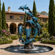 Monumental Mermaid and Leaping Dolphins Bronze Sculpture by Giant Sculptures with verdigris dolphins spiraling around the figure in a Mediterranean garden fountain.