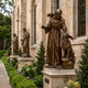 Monumental Traditional Robed Friar with Dove and Wolf Bronze Sculpture by Giant Sculptures displayed on a stone plinth beside a cathedral with other bronze saints.