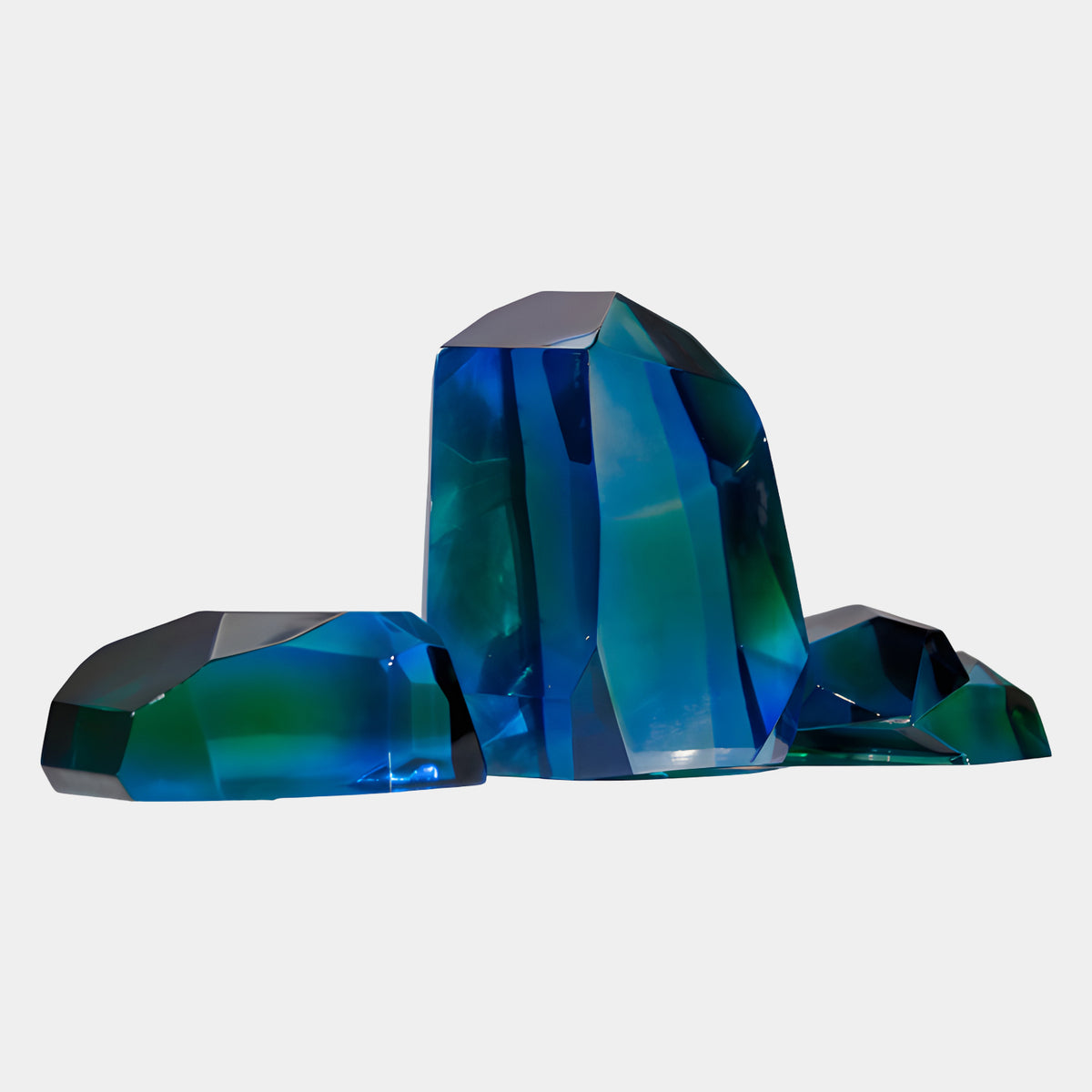 Blue & Green Faceted Boulder Resin Sculpture (35/42/45cm) by Giant Sculptures, three polished geometric forms in blue and emerald tones on a plain white background.
