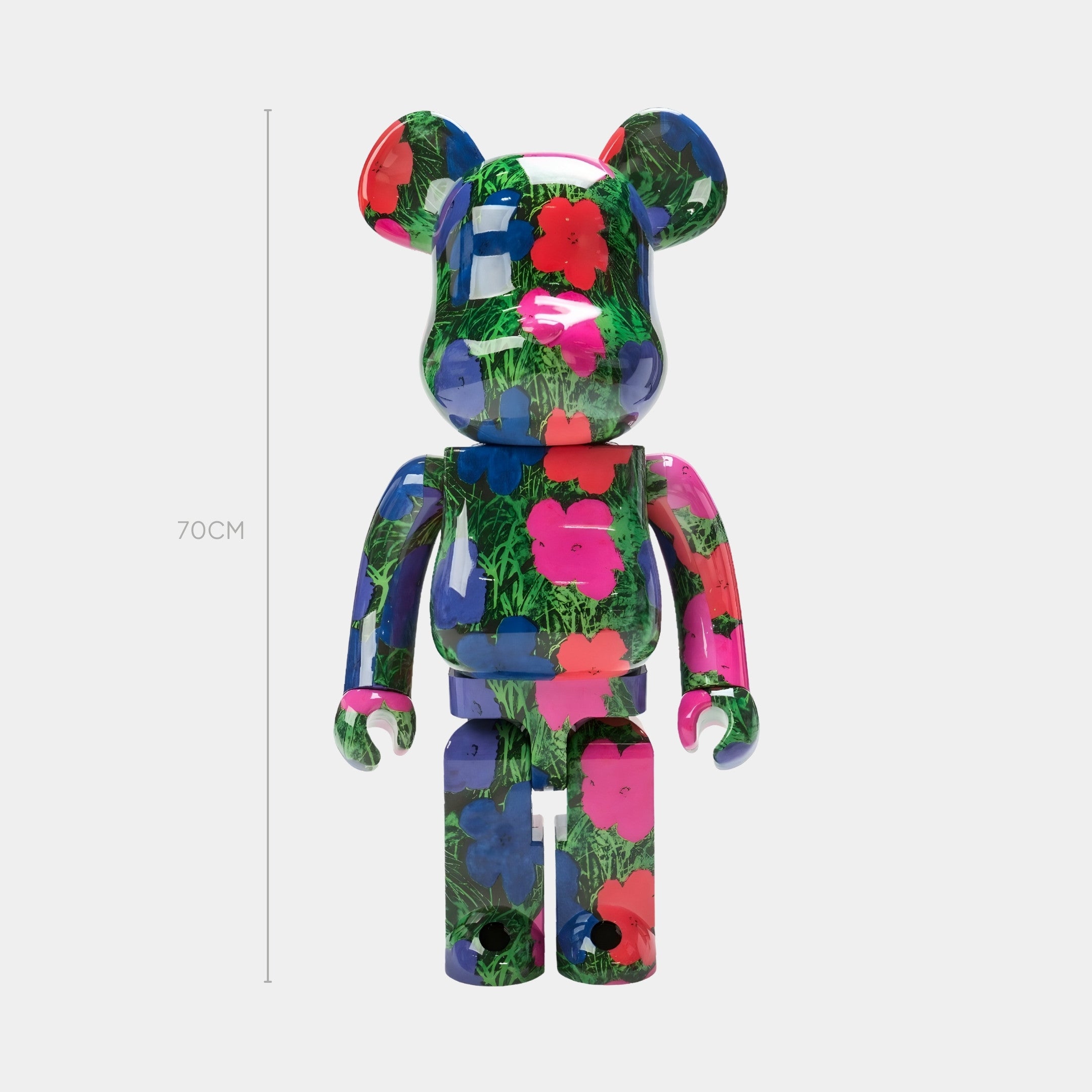 The Neon Meadow Bear Sculpture - 70cm by Giant Sculptures features premium gloss resin and vibrant, botanical-inspired graphics in pink, red, blue, and green. The upright figure stands out against a plain light background.