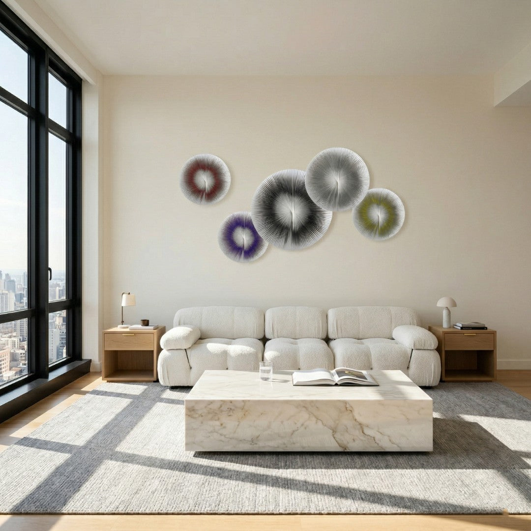 Centria II Multicolour Disc 5-Panel 3D Leather Wall Art by Giant Sculptures displayed in a modern living room above a cream sofa, featuring five radial folded leather discs in red, purple, black, grey, and olive tones.