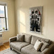 Giant Sculptures Apexline Motorsport Racing Suit Acrylic Box 3D Wall Art in black and white with red accents, mounted above a grey sofa in a sunlit living room.