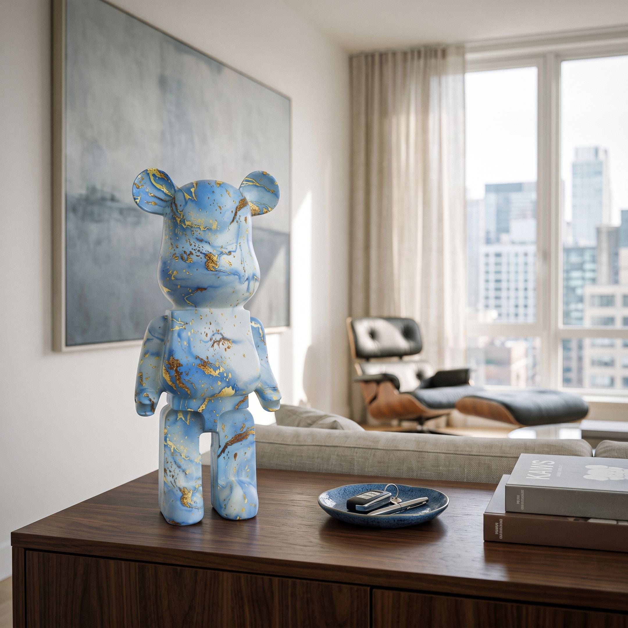 Ocean Spray Bear Sculpture - 50cm in blue and gold swirled resin with kintsugi-style veining, displayed on a wood sideboard in a living room with city views.