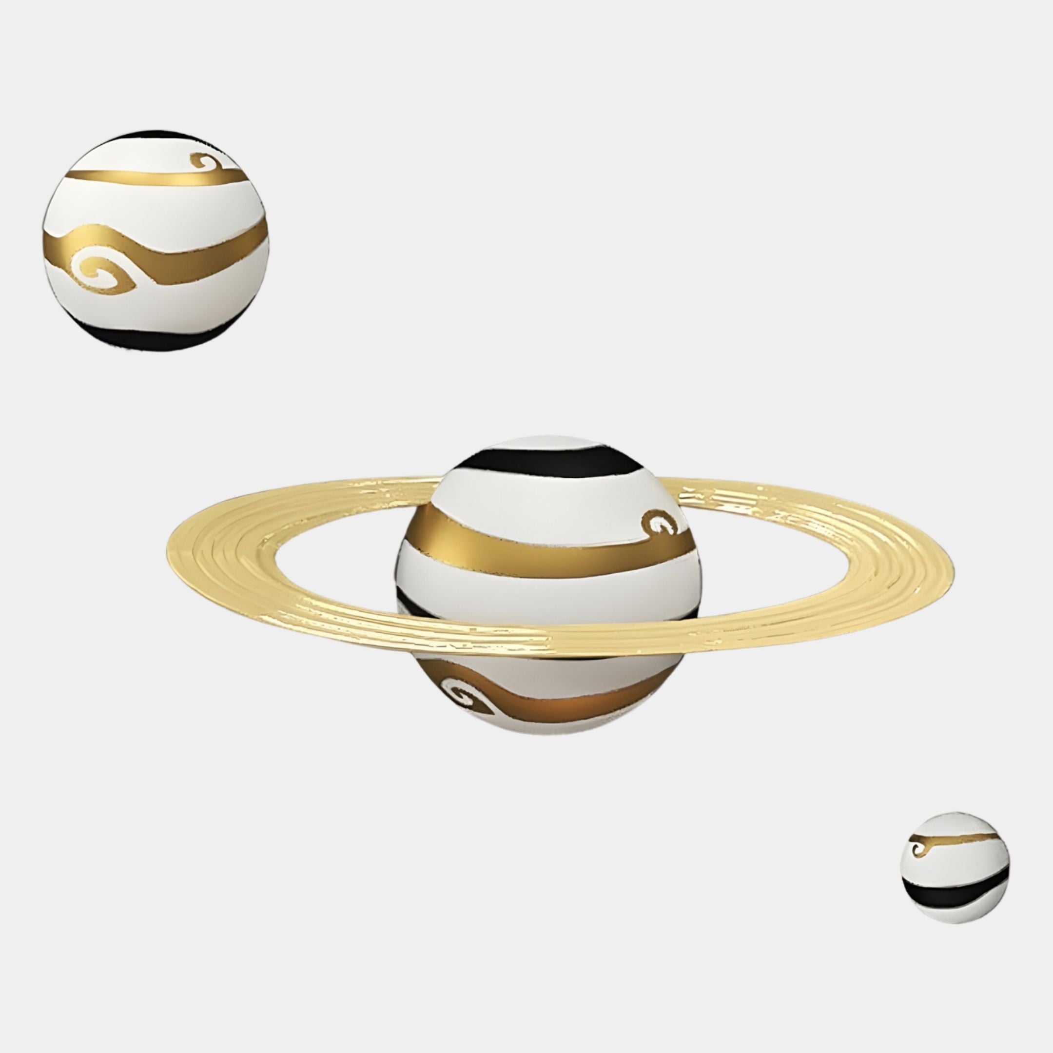 Three stylized planets in black, white, and gold swirls float on white. The largest has a gold ring, adding celestial charm to the White & Gold Orbit Planets 3D Wall Art by Giant Sculptures, crafted from durable resin.