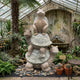 Three Stacked Turtles Granite Statue - 150cm in beige-grey stone, each turtle's head turned differently, displayed in a greenhouse setting among plants and cacti.
