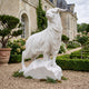 Standing Sheep White Marble Statue, 250cm, with raised head and ringed horns on a rocky base, displayed on a gravel path in a chateau garden.
