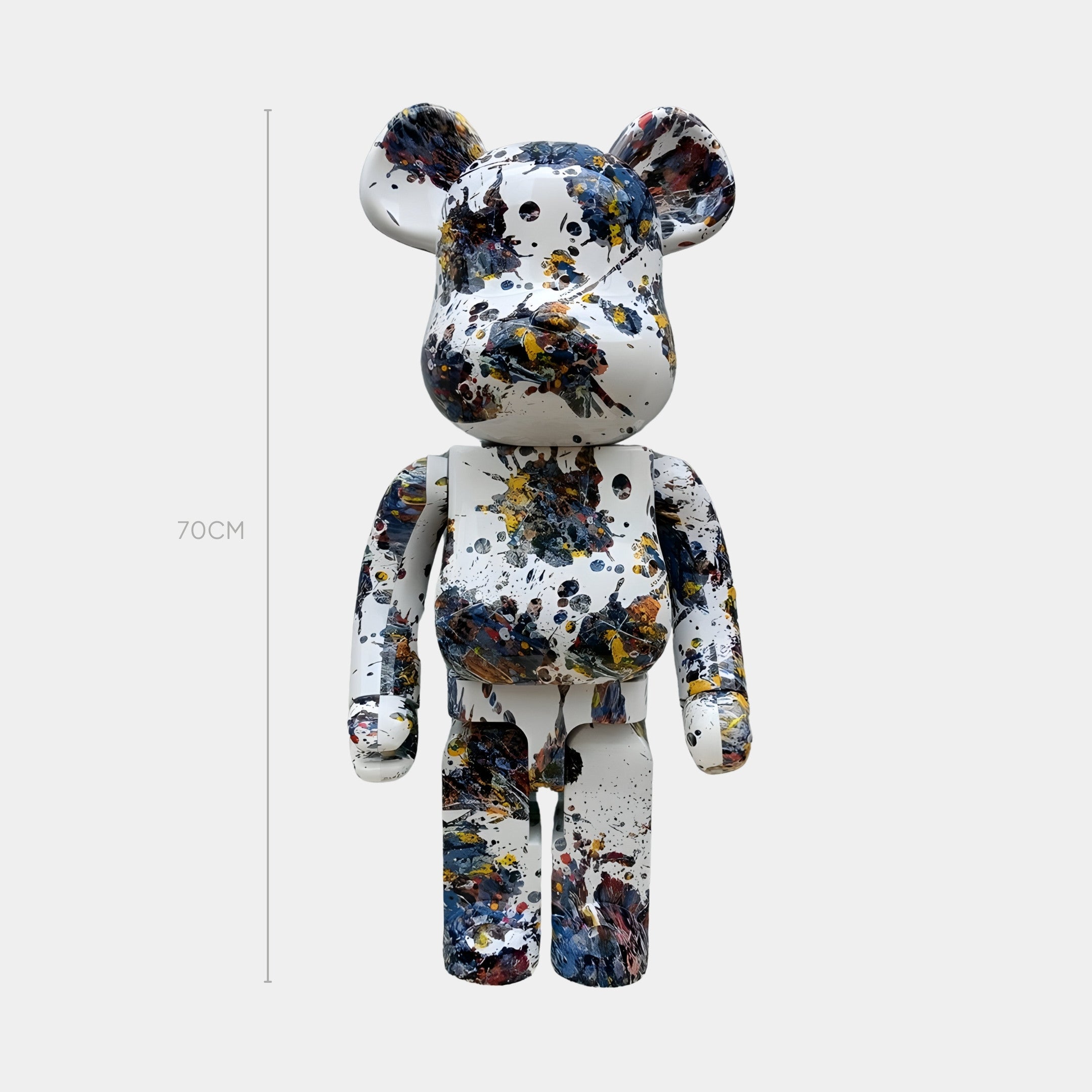 The Paint Splatter Bear Sculpture - 70cm by Giant Sculptures features a white base with black, blue, yellow, and red splatters—perfect for adding abstract expression to modern spaces. Displayed against a plain white background.