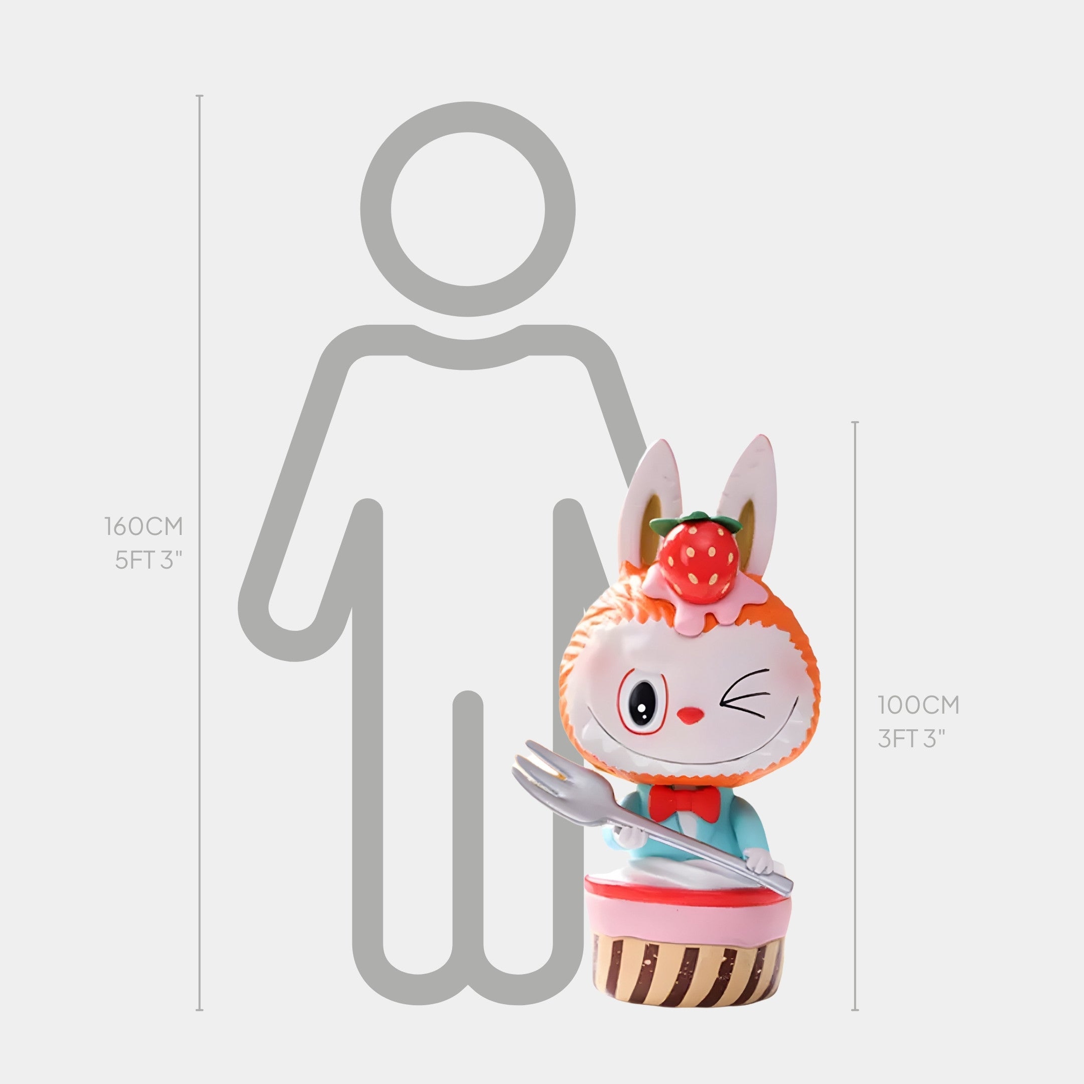 The Sweet Mischief Strawberry Wink Labubu Sculpture by Giant Sculptures features a rabbit with a strawberry on its head, cupcake base, and fork, standing 100 cm tall—shown beside a human silhouette for scale.