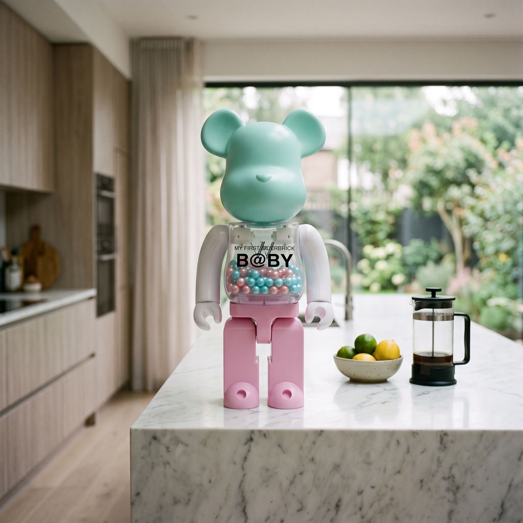 Pastel Pearl Beads Bear Sculpture, 70cm, with mint head, pink legs, and a transparent bead-filled chest, displayed on a marble kitchen island.