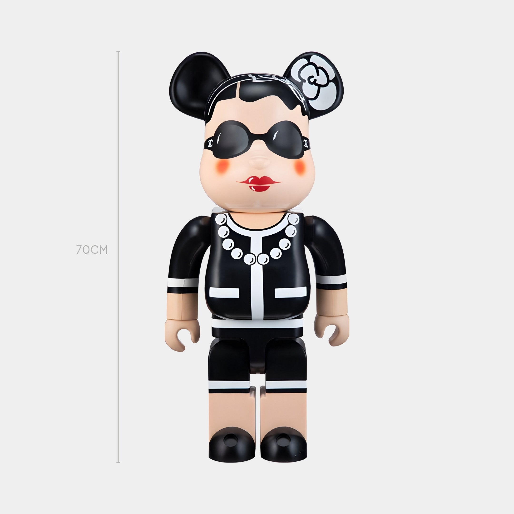 The Iconic Pearl Bear Sculpture - 70cm by Giant Sculptures features chic short black hair, black and white styling, sunglasses, a pearl necklace, red lips, and a mouse ear headpiece with a flower—a must-have collectible.